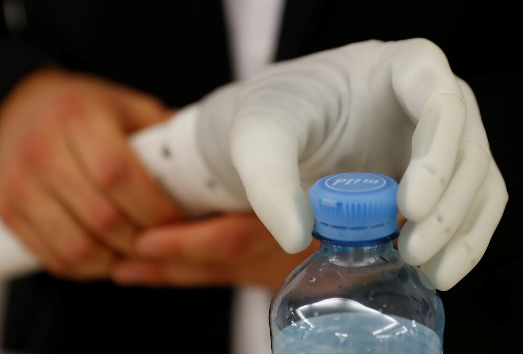 An employee holds an artificial hand prosthesis during the Ottobock media day in Vienna, Austria October 23, 2018. Picture taken October 23, 2018. REUTERS/Leonhard Foeger - RC156ADE7ED0