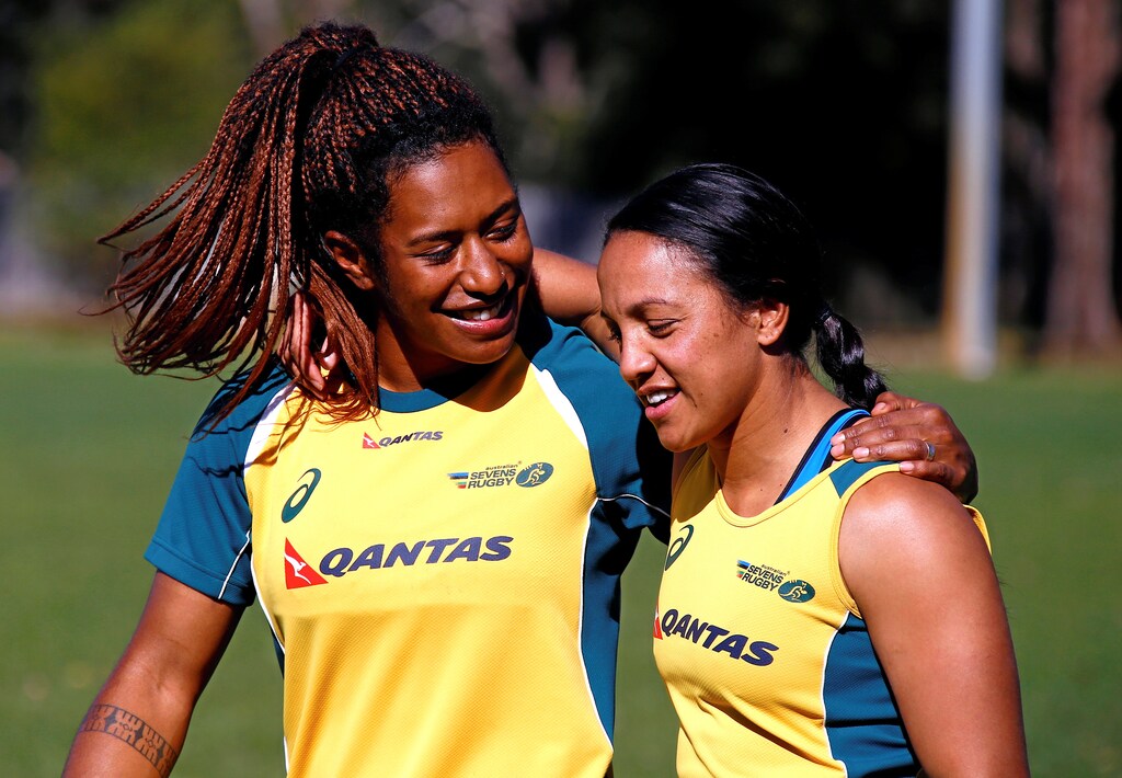 Members of the Australian Women's rugby sevens Olympic team Ellia Green (L) and Amy Turner embrace after a team training session in Sydney, Australia, July 22, 2016. Picture taken July 22, 2016. REUTERS/David Gray - S1BETSFOOZAB