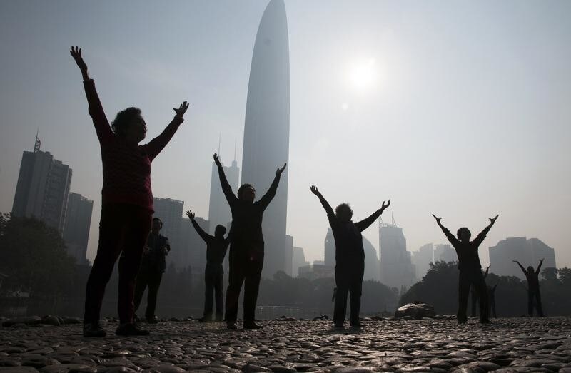 Residents do morning exercises at a park on a hazy day in Shenzhen, Guangdong province February 12, 2015. Nearly 90 percent of China's big cities failed to meet air quality standards in 2014, but that was still an improvement on 2013 as the country's "war on pollution" began to take effect, the environment ministry said on February 2. REUTERS/Stringer (CHINA - Tags: ENVIRONMENT SOCIETY) CHINA OUT. NO COMMERCIAL OR EDITORIAL SALES IN CHINA - GM1EB2C0YD101