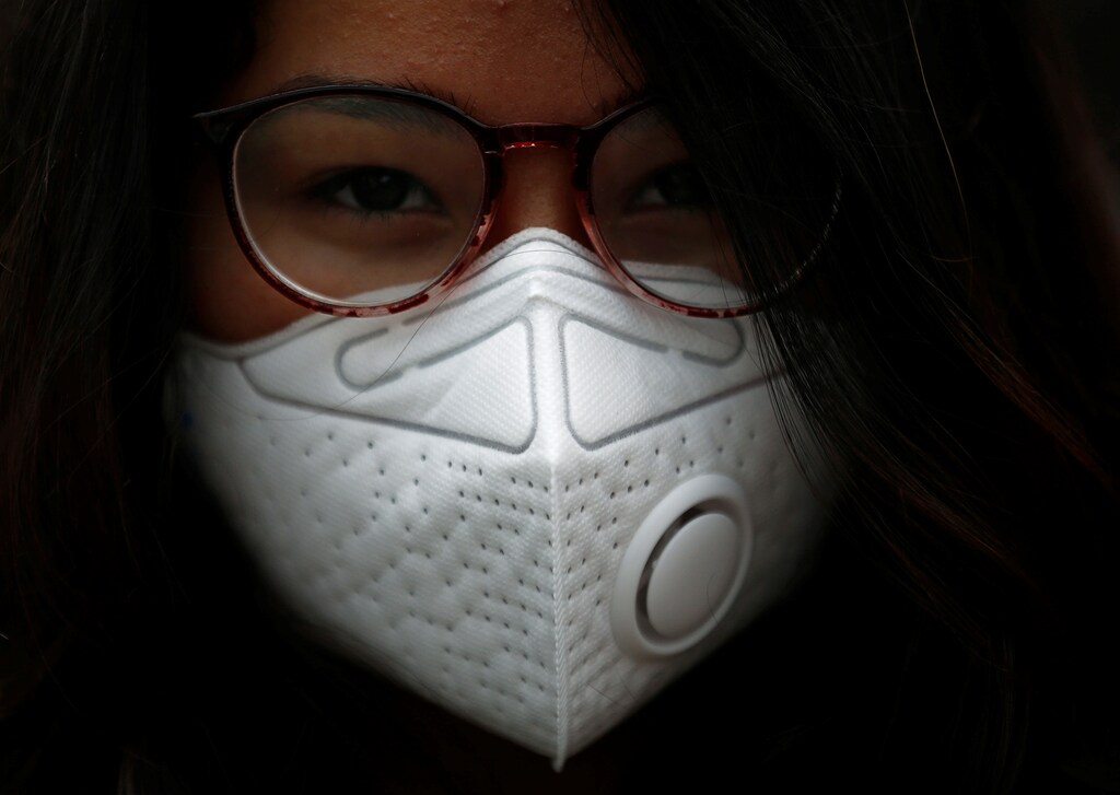 An activist wearing a mask takes part in a protest against what organisers say is air pollution caused by unpaved roads, during World Environment Day in Lalitpur, Nepal June 5, 2018.