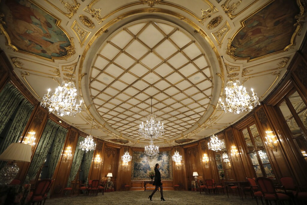 An employee walks through the lobby of the luxury hotel Le Bristol, in Paris, France, July 27, 2015. Nowhere in the world has more accommodation available on Airbnb than Paris. Now the home-sharing website that has transformed budget travel to the French capital is giving its super-deluxe hotels a fright too. Picture taken July 27, 2015. REUTERS/Stephane Mahe - RTX1NO18