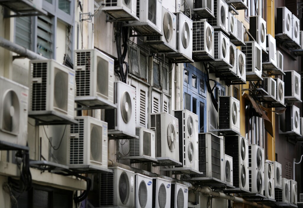 Air conditioners on the walls of a building in Singapore's financial district