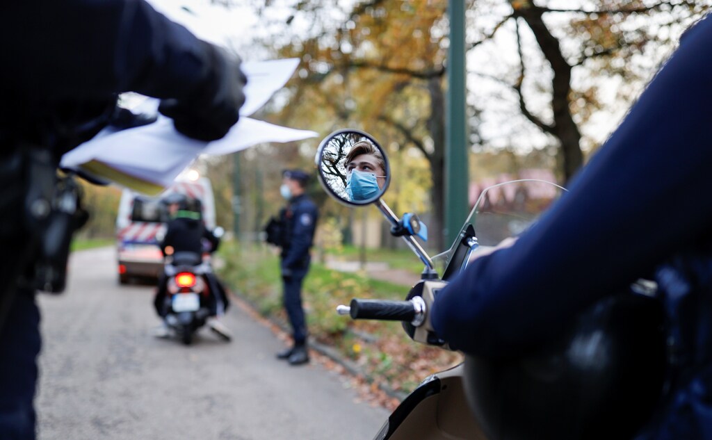 French police officers conduct a control to check exemption certificates and identity during the nationwide lockdown aimed at slowing the spread of the coronavirus disease (COVID-19), in the Bois de Boulogne area, in Paris, France, November 14, 2020. Picture taken November 14, 2020. REUTERS/Christian Hartmann - RC2P3K9J3SC2