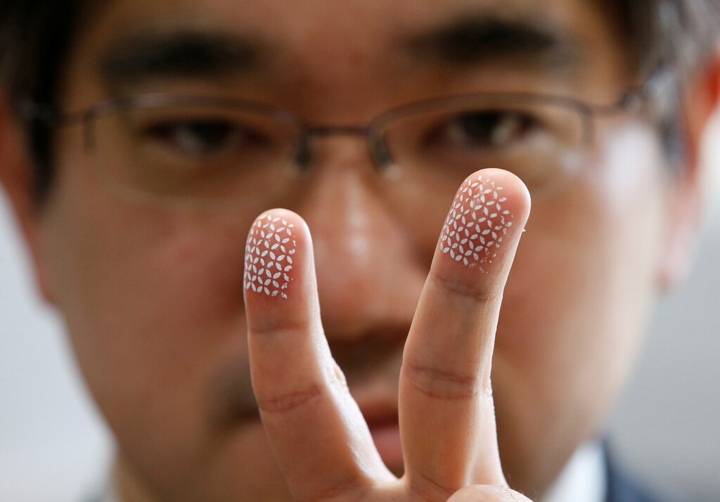 A Japanese professor demonstrates a home-made biometric jammer, used to prevent fingerprint theft