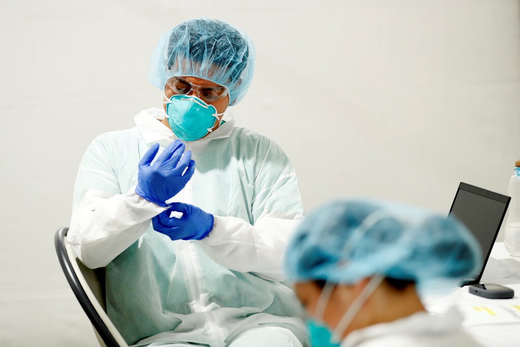 Healthcare workers don personal protective equipment (PPE) as they wait for patients to arrive for testing at a One Medical testing facility built to help with the coronavirus disease (COVID-19) outbreak, in the Bronx borough of New York City, U.S., April 21, 2020.