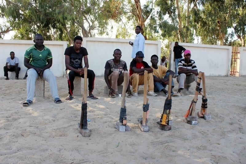 African migrants sit on the side of a road as they wait for work in Misrata, Libya, October 22, 2017. Picture taken October 22, 2017. REUTERS/ Ayman al-Sahili - RC16772AFFD0