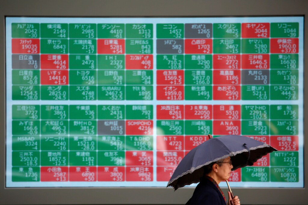 A passerby walks past in front of a stock quotation board outside a brokerage in Tokyo, Japan, May 10, 2019. REUTERS/Issei Kato - RC1C3FC9F440