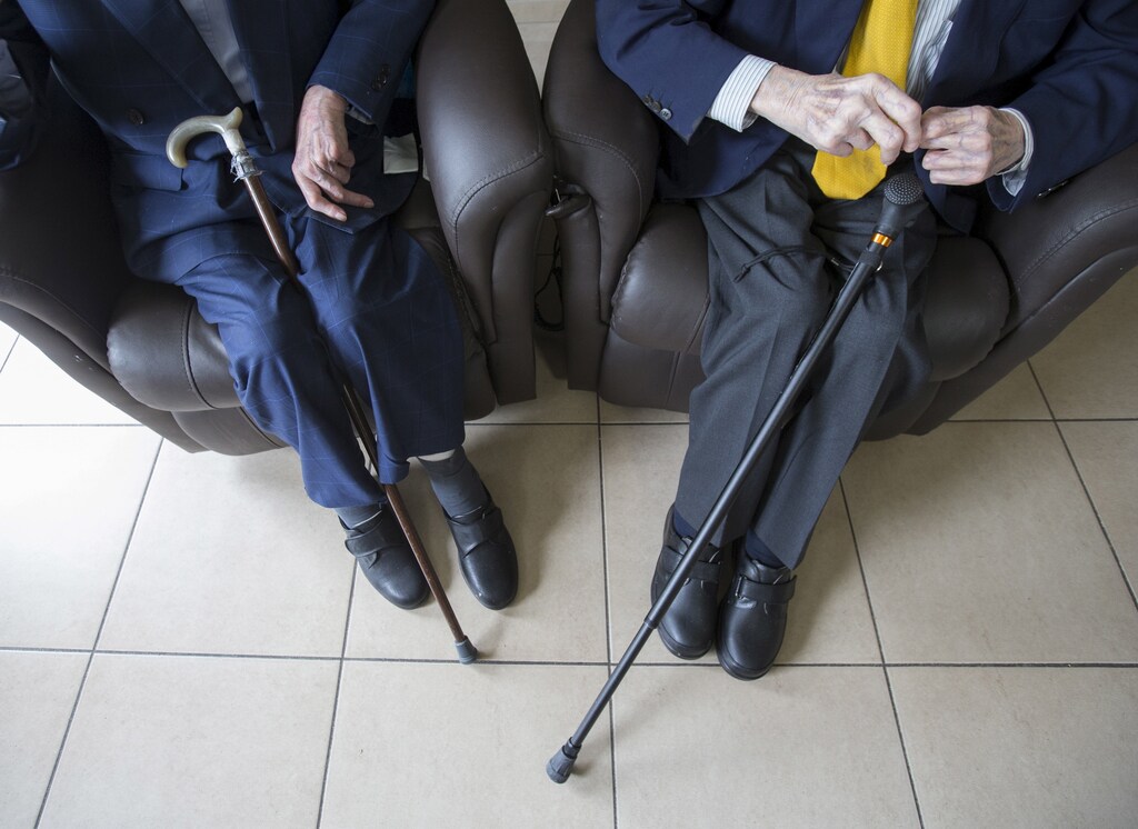 The world's oldest living twin brothers, Paulus and Pieter Langerock from Belgium, 102, sit in their living room at the Ter Venne care home in Sint-Martens-Latem, Belgium, August 11, 2015. Born on July 8 1913, they never married and until this day sleep side by side in the same room. Eating in moderation, drinking a glass of good wine every day and avoiding chasing women are the secrets of a long life, Belgians Pieter and Paulus Langerock, the world's oldest living twin brothers, say. The brothers have lived together for most of their lives and until this day barely leave each other's side, sharing a room at their nursing home just outside the Belgian town of Ghent. Picture taken August 11, 2015. REUTERS/Yves Herman - GF20000020299