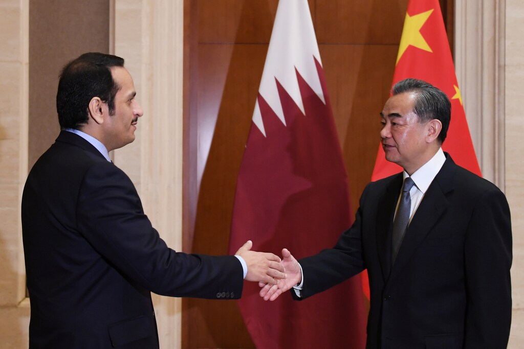 Qatar's Foreign Minister Mohammed bin Abdulrahman bin Jassim Al Thani (L) is greeted by Chinese Foreign Minister Wang Yi before a meeting in Beijing's Diaoyutai State Guesthouse on December 12, 2018. Greg Baker/Pool via Reuters