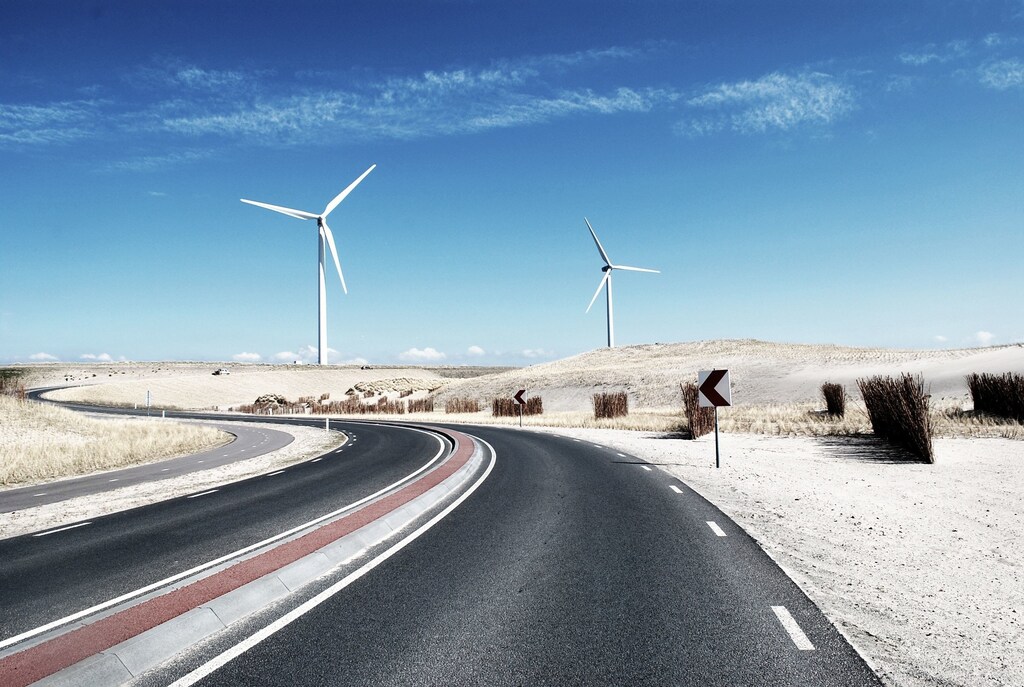 A wind farm beside a road.