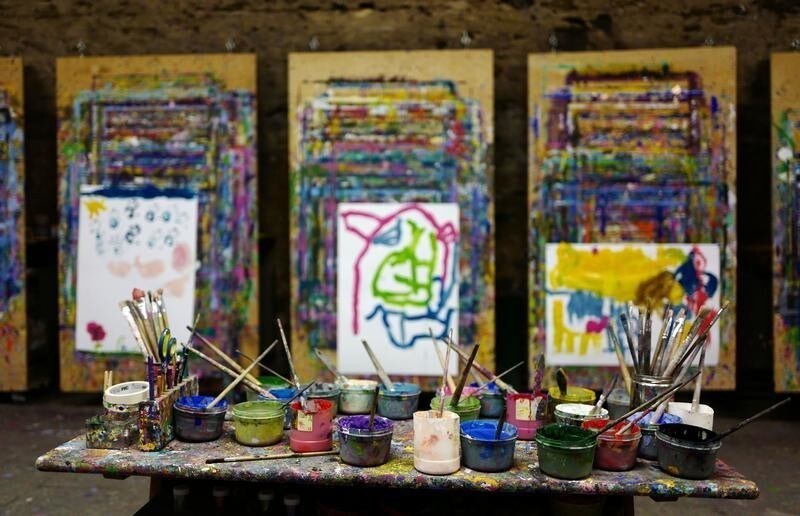 Paint in different colors are seen on a table at an art class for children in the city of Hanau near Frankfurt, Germany, March 7, 2016. REUTERS/Kai Pfaffenbach - D1AESTAVYTAB