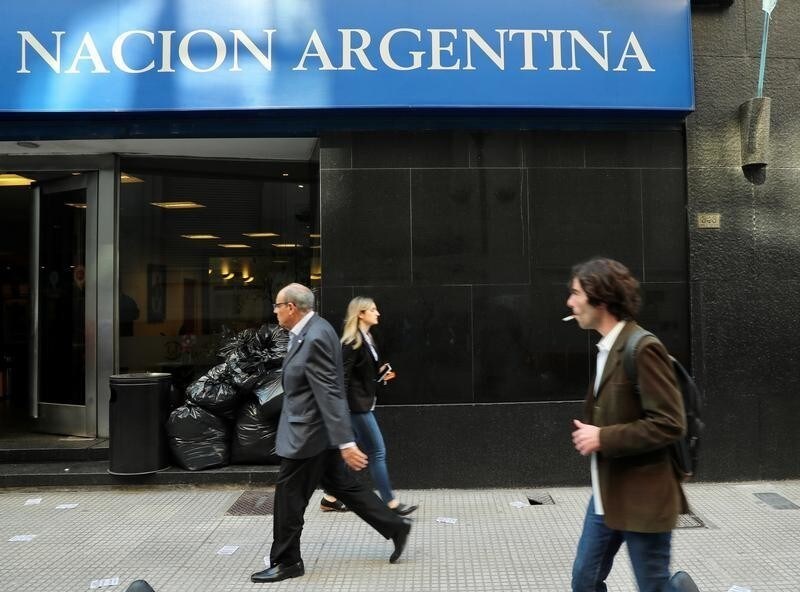 People walk by a bank in Buenos Aires' financial district, Argentina August 29, 2018.
