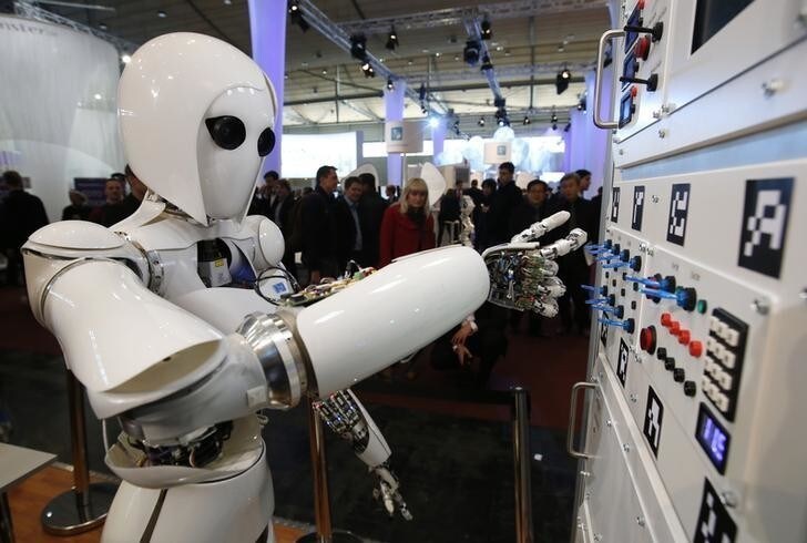 The humanoid robot AILA (artificial intelligence lightweight android) operates a switchboard during a demonstration by the German research centre for artificial intelligence at the CeBit computer fair in Hanover March, 5, 2013. The biggest fair of its kind open its doors to the public on March 5 and will run till March 9, 2013. REUTERS/Fabrizio Bensch (GERMANY - Tags: BUSINESS SCIENCE TECHNOLOGY)