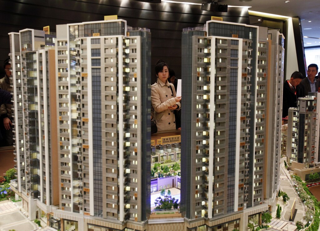 A potential buyer looks at a model of Riva, one of the latest developments by Sun Hung Kai Properties, in Hong Kong February 19, 2014. REUTERS/Bobby Yip