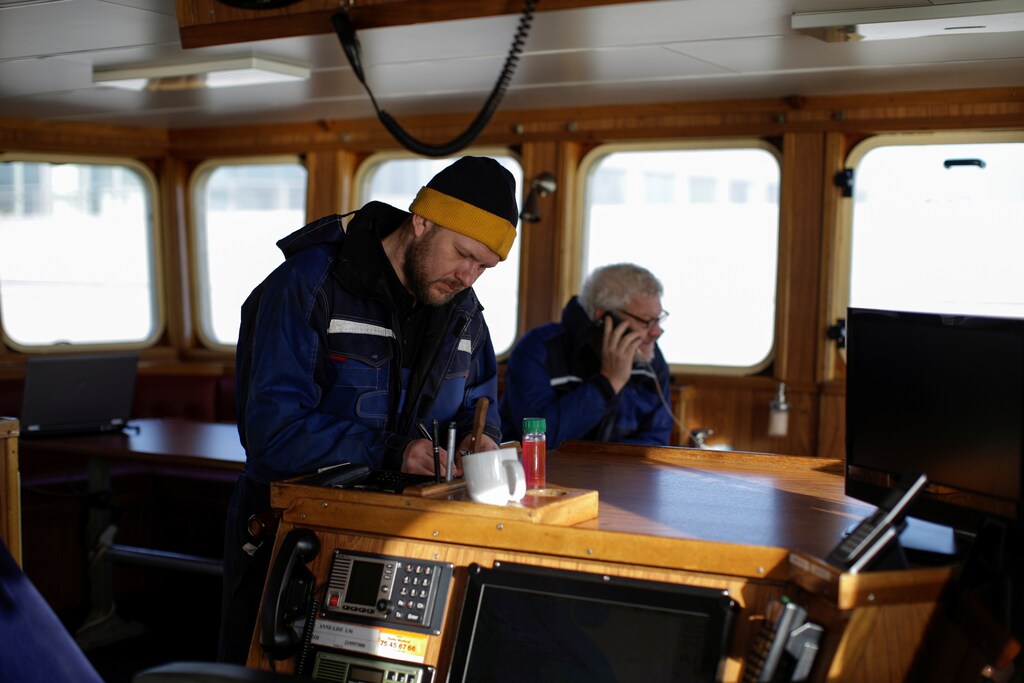 Skipper and third generation fisherman from Thyboron Poul-Erik Rom, 35, works on the bridge with his father Ejvind Rom, 65, on their ship Anna-Lise in the village of Thyboron in Jutland, Denmark, March 18, 2019. Each year Poul Erik and his father land fish worth some 25 million Danish Crowns ($3.75 million) from their vessel, one third of which come from British waters. "I like the unpredictability of fishing. Sometimes we catch 200 kilos, sometimes two tonnes, and we never know what prices we will get," he said. "It seems like we have to sail further and further away from the shore to find the fish," said Poul Erik, who worries what will happen if he is restricted access to British water. The problem for Poul Erik and his father is that as the water warms due to climate change, the fish they rely on such as cod and haddock tend to swim towards colder waters nearer the UK and further north. REUTERS/Andrew Kelly SEARCH "KELLY JUTLAND" FOR THIS STORY. SEARCH "WIDER IMAGE" FOR ALL STORIES. - RC1B99AB4630