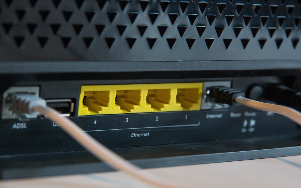 a picture of the back of a wifi box with cables coming out of it