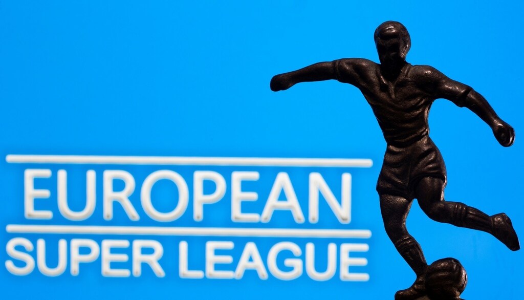 A metal figure of a football player with a ball is seen in front of the words "European Super League" in this illustration taken April 20, 2021. REUTERS/Dado Ruvic/Illustration - RC2QZM99RK4T