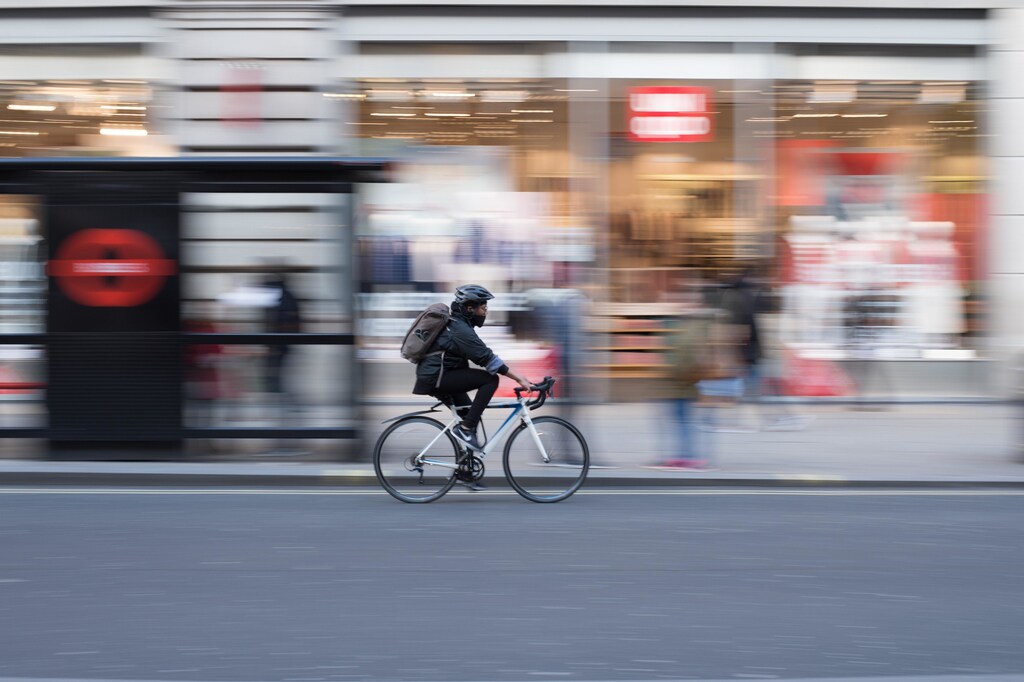 image of a person riding a bike and wearing a mask