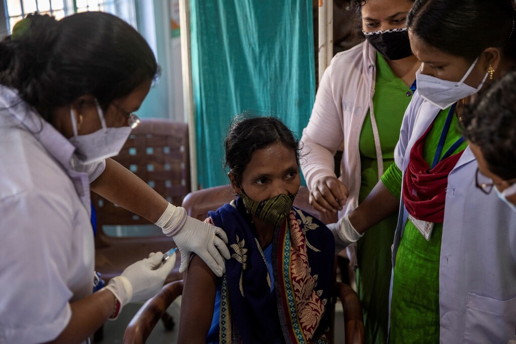 Reena Jani, 34, a health worker, receives the vaccine developed by Oxford/AstraZeneca at Mathalput Community Health Centre, during the coronavirus disease (COVID-19) pandemic, in Koraput, India, January 16, 2021. Jani's name was on a list of 100 health workers at Mathalput Community Health Centre, making her one of the first Indians to be inoculated against COVID-19 earlier this month, as the country rolls out a vaccination programme the government calls the world's biggest. But she had heard rumours of serious side effects and worried about what would happen were she to get ill. "I was frightened because of my son and daughters. If something happens to me, what will they do?" Jani said. REUTERS/Danish Siddiqui SEARCH "SIDDIQUI OXFORD/ASTRAZENECA" FOR THIS STORY. SEARCH "WIDER IMAGE" FOR ALL STORIES. TPX IMAGES OF THE DAY. - RC2SEL9ODK0Y