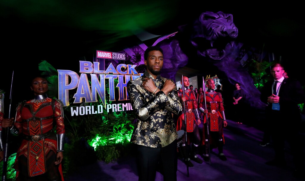 Black Panther actor Chadwick Boseman poses Wakanda-style at the film's premiere.