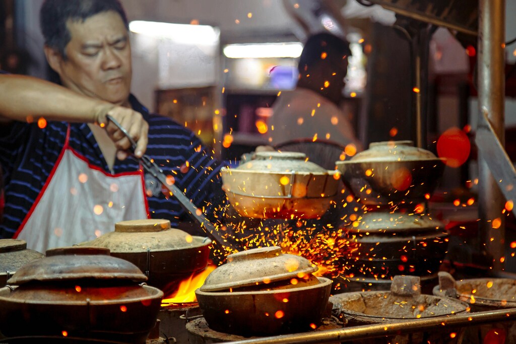 Man making cookware with sparks flying in Kuala Lumpur, Malaysia: The Centre for the Fourth Industrial Revolution in Malaysia is piloting an energy literacy programme