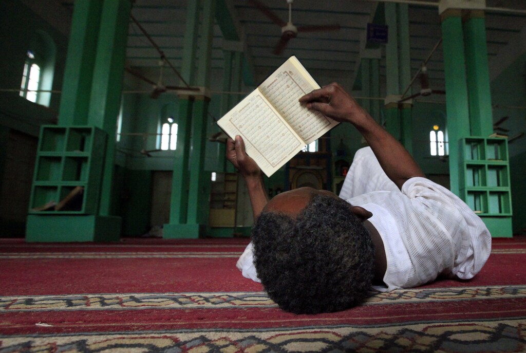 A man reads the Koran on the first Friday of Ramadan in a mosque at Umdowan Ban village outside Khartoum August 5, 2011. REUTERS/Mohamed Nureldin Abdallah (SUDAN - Tags: RELIGION IMAGES OF THE DAY) - GM1E7860FV201