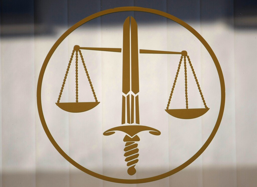 The symbol of Justice, with the sword and the scales, is seen in a lawyers cabinet in Nice, southeastern France, October 9, 2009. REUTERS/Eric Gaillard (FRANCE CRIME LAW) - RTXPGJ1