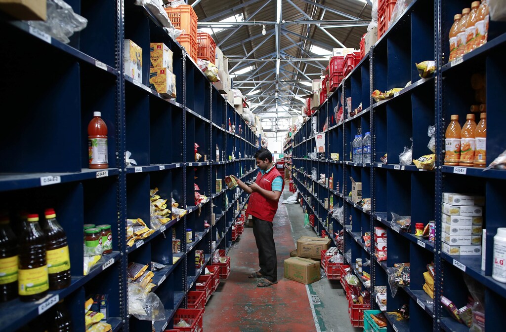 an packer in a warehouse scans an item a customer has ordered online ordered online