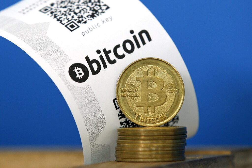 A Bitcoin (virtual currency) paper wallet with QR codes and coins are seen in an illustration picture taken at La Maison du Bitcoin in Paris July 11, 2014. French police dismantled an illegal Bitcoin exchange and seized 388 virtual currency units worth some 200,000 euros ($272,800) in the first such operation in Europe a public prosecutor said on Monday. REUTERS/Benoit Tessier (FRANCE - Tags: BUSINESS) - PM1EA7B1GZZ01