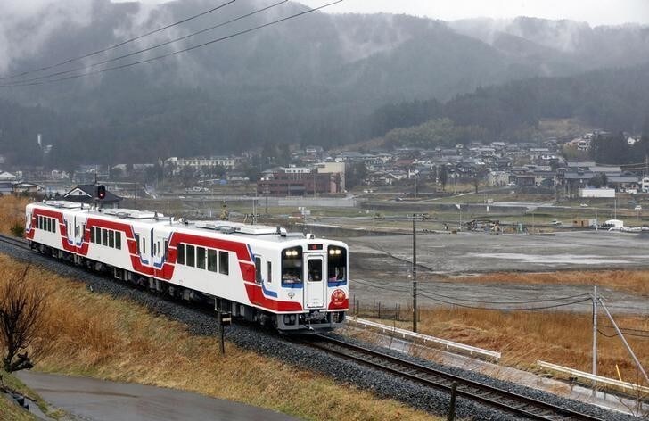 A special train runs near Okirai area which was devastated by the March 11, 2011 earthquake and tsunami, on the Minami Riasu Line in Ofunato, Iwate Prefecture, in this photo taken by Kyodo April 3, 2013. A Sanriku Railway Co. line crippled by the March 2011 disaster partially reopened for service on Wednesday, with new carriages bought with the help of the Kuwaiti government, Kyodo reported. A special train to mark the partial reopening of Minami Riasu Line after some two years will run along a 21.6 kilometer stretch between Sakari and Yoshihama stations in Ofunato, Iwate Prefecture. Mandatory Credit. REUTERS/Kyodo (JAPAN - Tags: DISASTER) ATTENTION EDITORS - THIS IMAGE WAS PROVIDED BY A THIRD PARTY. THIS PICTURE IS DISTRIBUTED EXACTLY AS RECEIVED BY REUTERS, AS A SERVICE TO CLIENTS. FOR EDITORIAL USE ONLY. NOT FOR SALE FOR MARKETING OR ADVERTISING CAMPAIGNS. MANDATORY CREDIT. JAPAN OUT. NO COMMERCIAL OR EDITORIAL SALES IN JAPAN