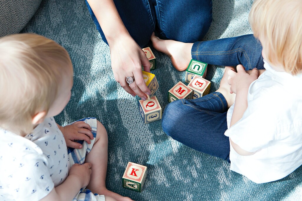 Mental health: Children playing with letter blocks.