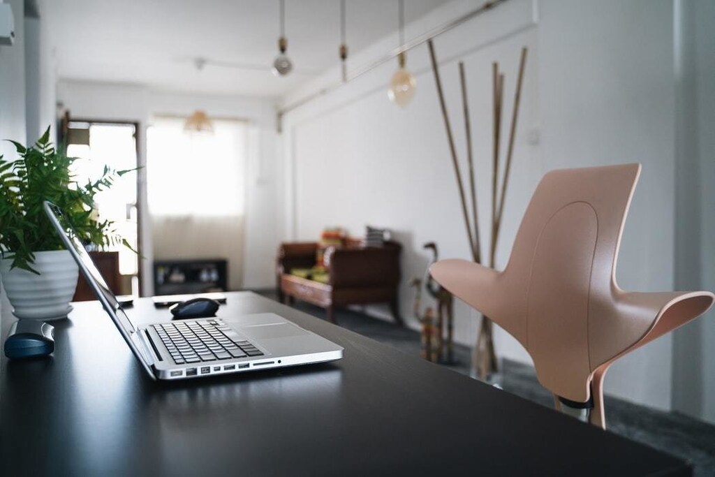 A home office, occupied by a laptop and chair.