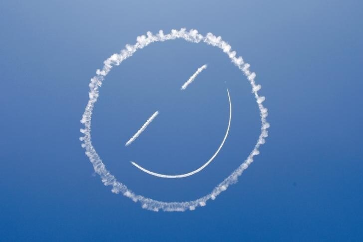 A sky writer draws a smiley face in the sky at the start of the Los Angeles County Air Show at the General William J. Fox Airfield in Lancaster, California, March 21, 2014. REUTERS/David McNew (UNITED STATES - Tags: MILITARY SOCIETY TRANSPORT)