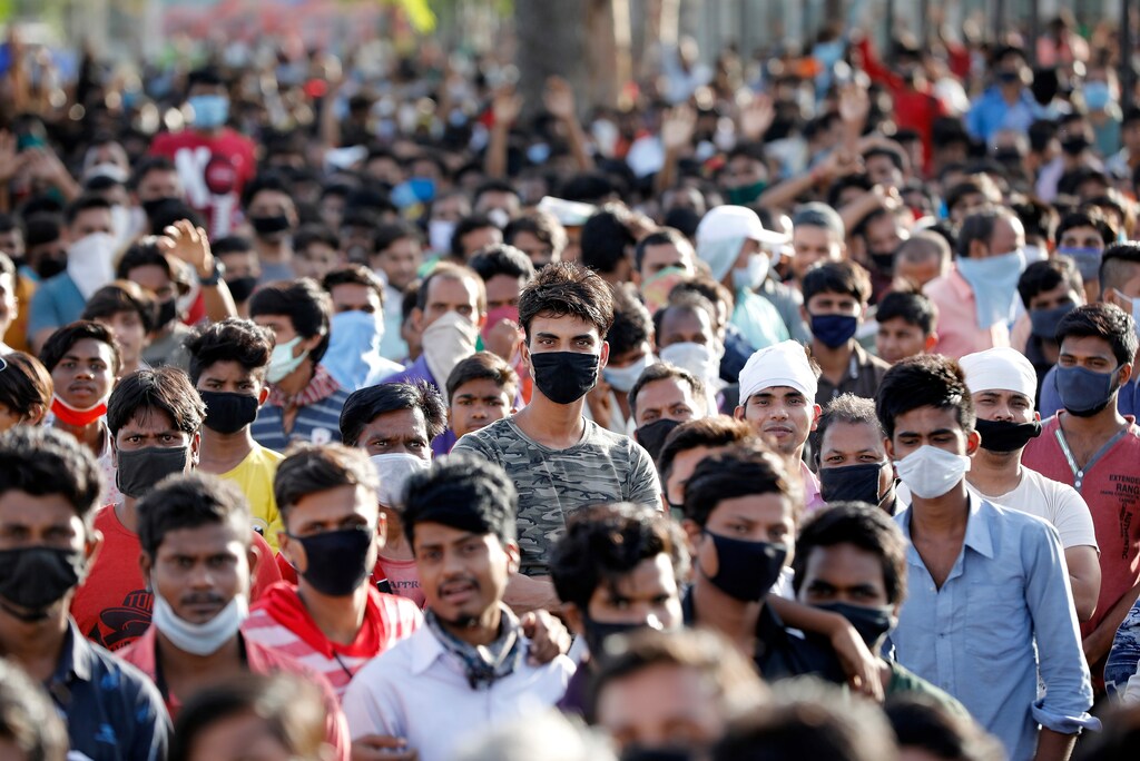 India's migrant workers wait for transport to leave Ahmedabad during an extended lockdown