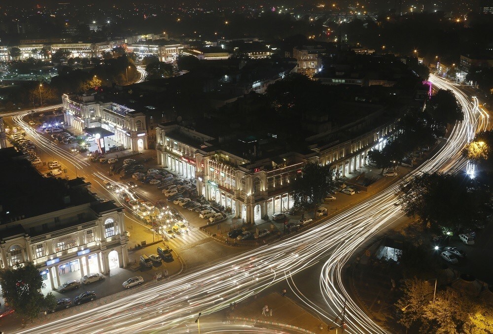 Vehicles move along New Delhi's Connaught Place during evening hours, October 28, 2014. India has the world's deadliest roads, the result of a flood of untrained drivers, inadequate law enforcement, badly maintained highways and cars that fail modern crash tests. Alarmed by the increasing fatalities, the new government has begun a five-year project to cut road deaths by a fifth every year, part of the most ambitious overhaul of highway laws since independence in 1947.?Picture taken October 28, 2014. To match Feature INDIA-DRIVING/ Picture is taken using slow shutter speed. REUTERS/Anindito Mukherjee