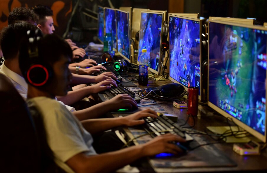 people play online games at an internet cafe in Fuyang, Anhui province, China