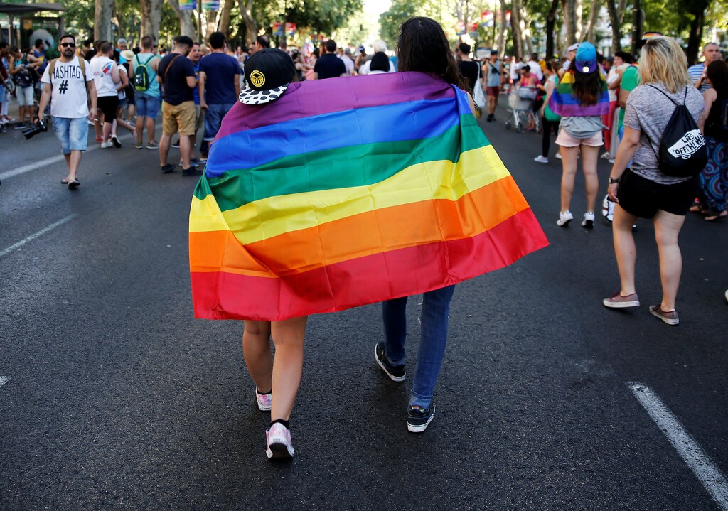 Revellers walk wrapped in a flag during a gay pride parade in downtown Madrid, Spain Lucia Gallego teenage feminist Nuria Ardid Madrid, Spain Thomson Reuters Foundation women men female male girls boys teenagers teens development gender gap parity equality diversity progress change feminine masculine woman man sex biology roles dynamic balance bias androgynous children kids child advocacy rights families policy law court courts lawyers court cases legal case argument politics democracy capitalism socialism fairness economics government govern administration system power voting votes elections electing faith trust electorate legislature omen men female male girls boys teenagers teens development gender gap parity equality diversity progress change feminine