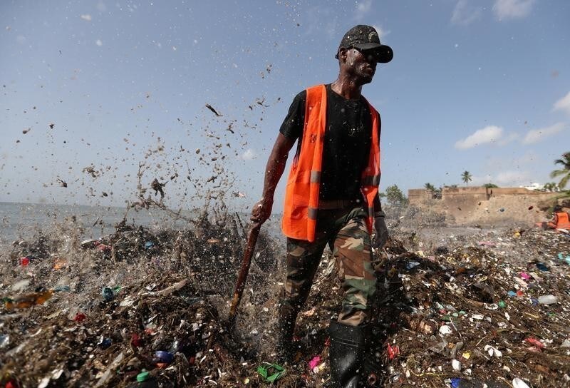 A soldier walks on the shores of Montesinos beach, which is covered in plastic and other debris, during a cleanup in Santo Domingo, Dominican Republic July 19, 2018. REUTERS/Ricardo Rojas - RC122A599800