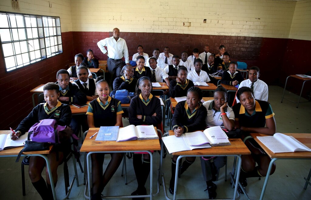 Teacher Reginald Sikhwari poses for a picture with his class of grade 11 students at Sekano-Ntoane school in Soweto, South Africa, September 17, 2015.