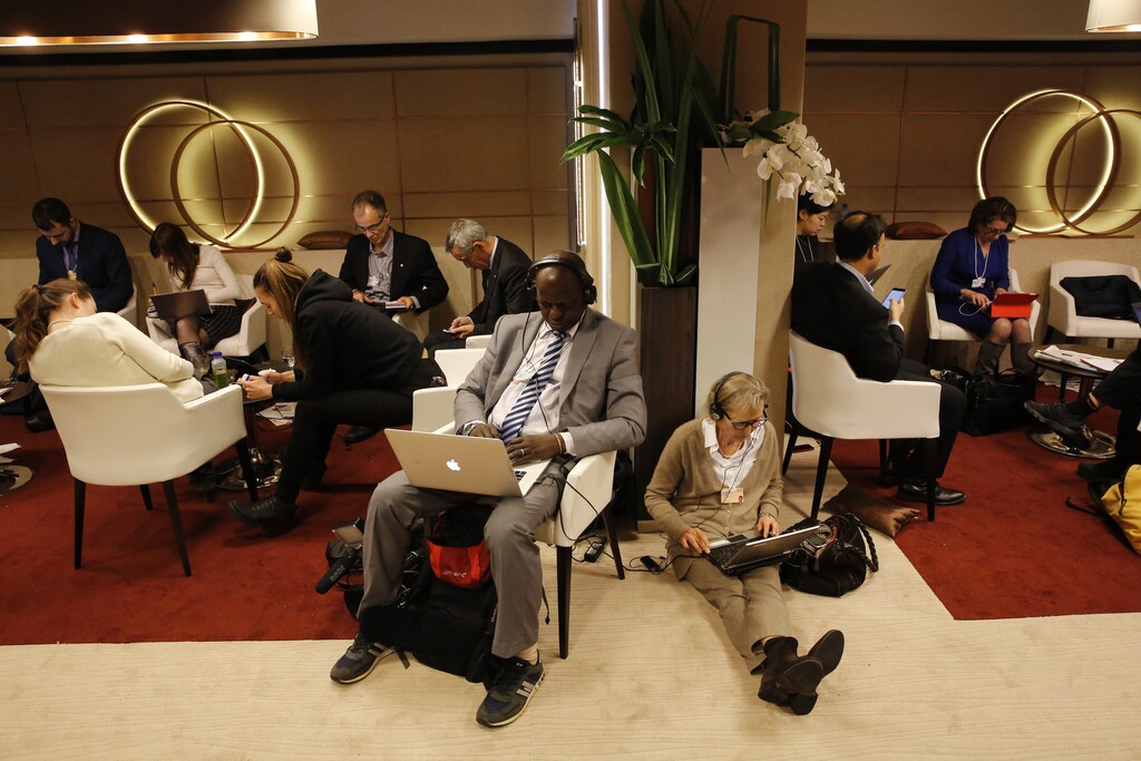Participants use their smart phones and laptops between sessions during the annual meeting of the World Economic Forum (WEF) in Davos, Switzerland January 22, 2016.
