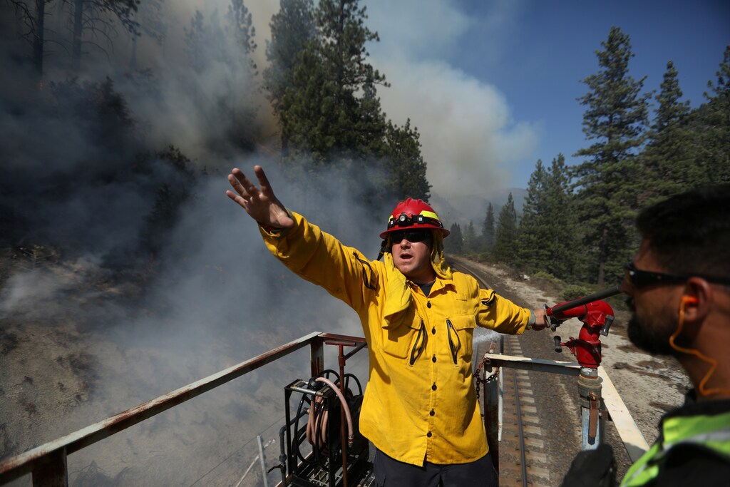 a firefighter shouts orders while fighting a wildfire