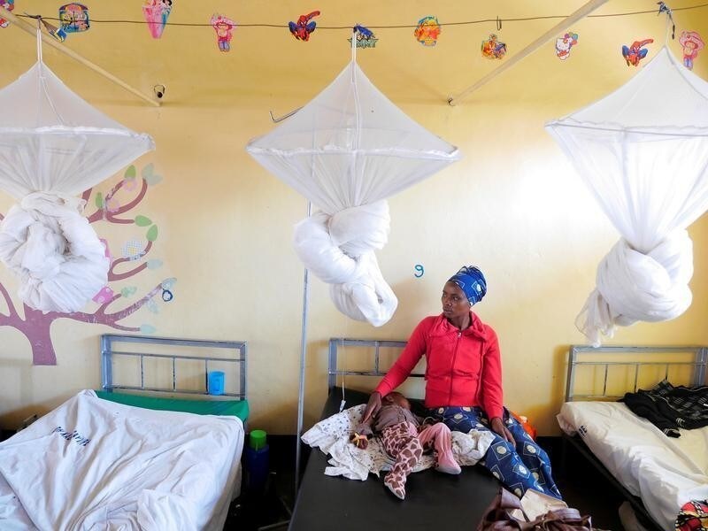 A mother looks after her son who was admitted at Kabgayi hospital as he sobs in his hospital bed in south of Rwanda capital Kigali where Zipline a California-based robotics company delivered their first blood to patients using a drone October 13, 2016.