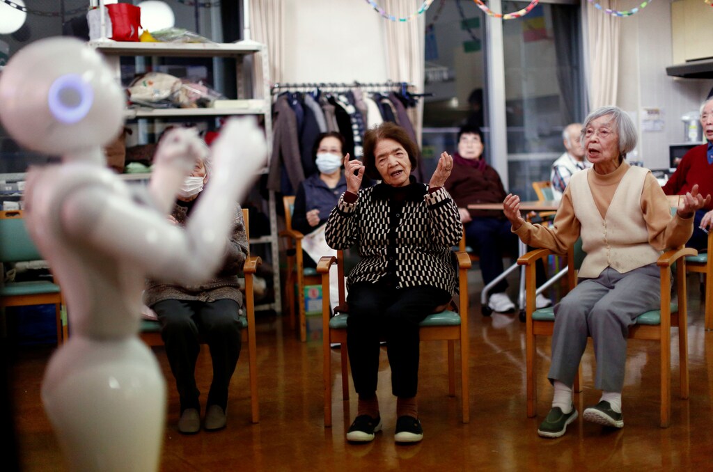 Residents follow moves made by humanoid robot 'Pepper' during an afternoon exercise session at a nursing home in Tokyo.