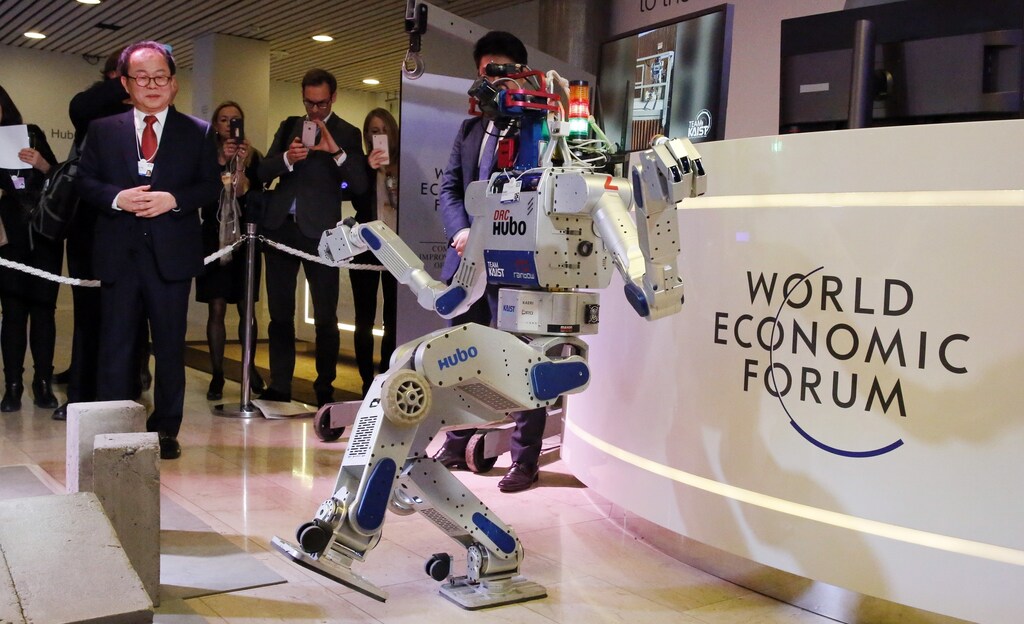 HUBO, a multifunctional walking humanoid robot performs a demonstration of its capacities next to its developer Oh Jun-Ho, Professor at the Korea Advanced Institute of Science and Technology (KAIST) during the annual meeting of the World Economic Forum (WEF) in Davos, Switzerland January 20, 2016.