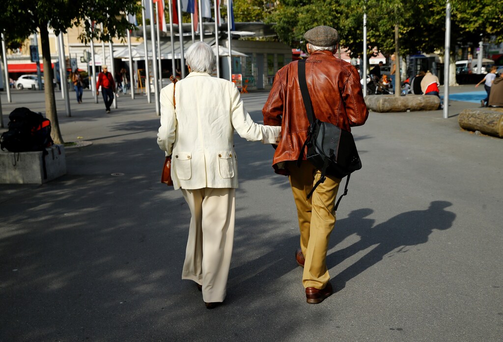 Elderly people walk in the street, ahead of a national vote on pensions reform, in Lausanne, Switzerland September 22, 2017. REUTERS/Denis Balibouse - RC12271D4B10