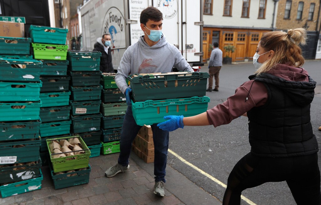 Executive chef of Annabel's private members club Julien Jouhannaud helps to load meals for NHS workers into vans, after they were prepared at their premises in London, Britain, May 11, 2020. Picture taken May 11, 2020. REUTERS/Peter Nicholls - RC2MNG92GUM1