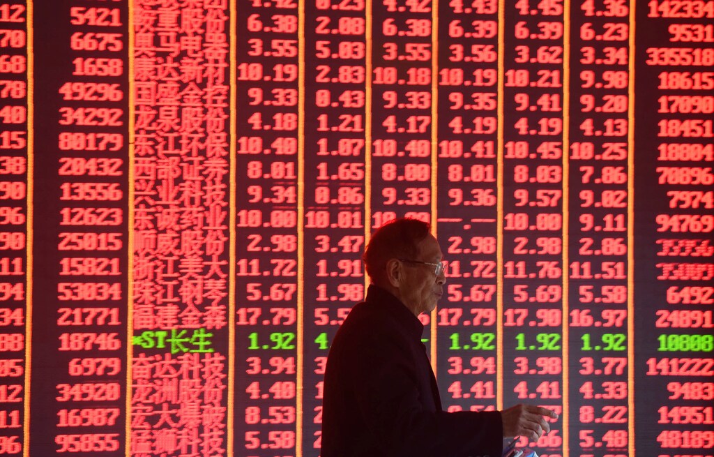 A man is seen in front of an electronic board showing stock information on the first day of trading in the Year of the Pig, following the Chinese Lunar New Year holiday, at a brokerage house in Hangzhou, Zhejiang province, China February 11, 2019. REUTERS/Stringer ATTENTION EDITORS - THIS IMAGE WAS PROVIDED BY A THIRD PARTY. CHINA OUT. - RC1BBA5F8720
