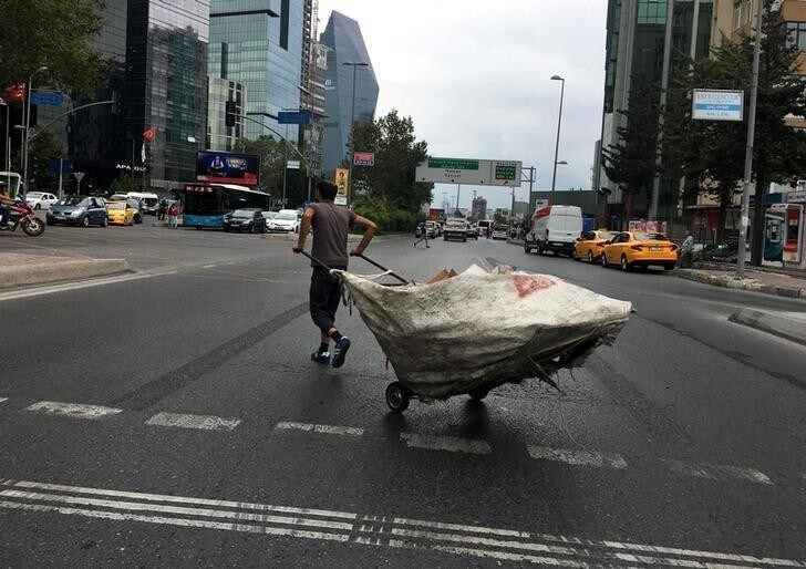 A man pulls a cart filled with recycling materials that he collected in the streets of the business and financial Levent district in Istanbul, Turkey, August 15, 2017. REUTERS/Murad Sezer