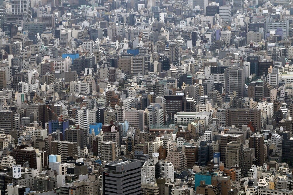 Medium-rise and low-rise residences and office buildings are seen from the first observatory deck of Tokyo Sky Tree in Tokyo October 30, 2011. The Tokyo Sky Tree, which is under construction, will stand 634 metres (2,080 feet) high upon completion, and will be the tallest stand-alone communications tower in the world. The Tokyo Sky Tree's grand opening is on May 22, 2012. REUTERS/Issei Kato (JAPAN - Tags: SCIENCE TECHNOLOGY CITYSPACE) - RTR2TEOE
