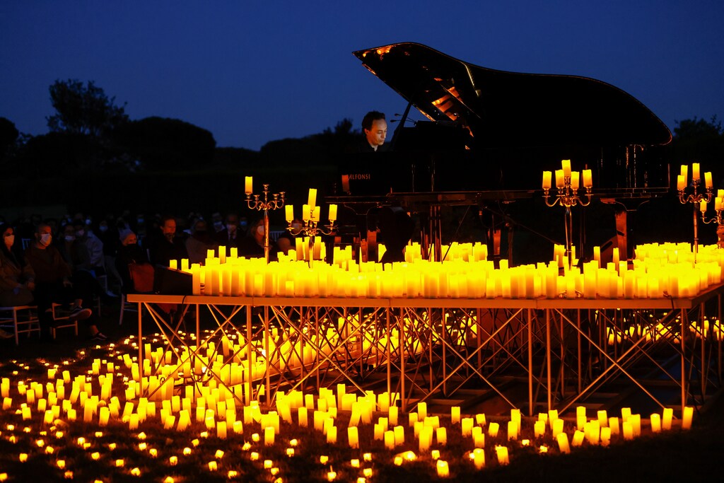 Pianist Giuseppe Califano plays during a candlelight concert inside the archaeological park of Appia Antica, during the coronavirus disease (COVID-19) pandemic, in Rome, Italy, May 10, 2021.